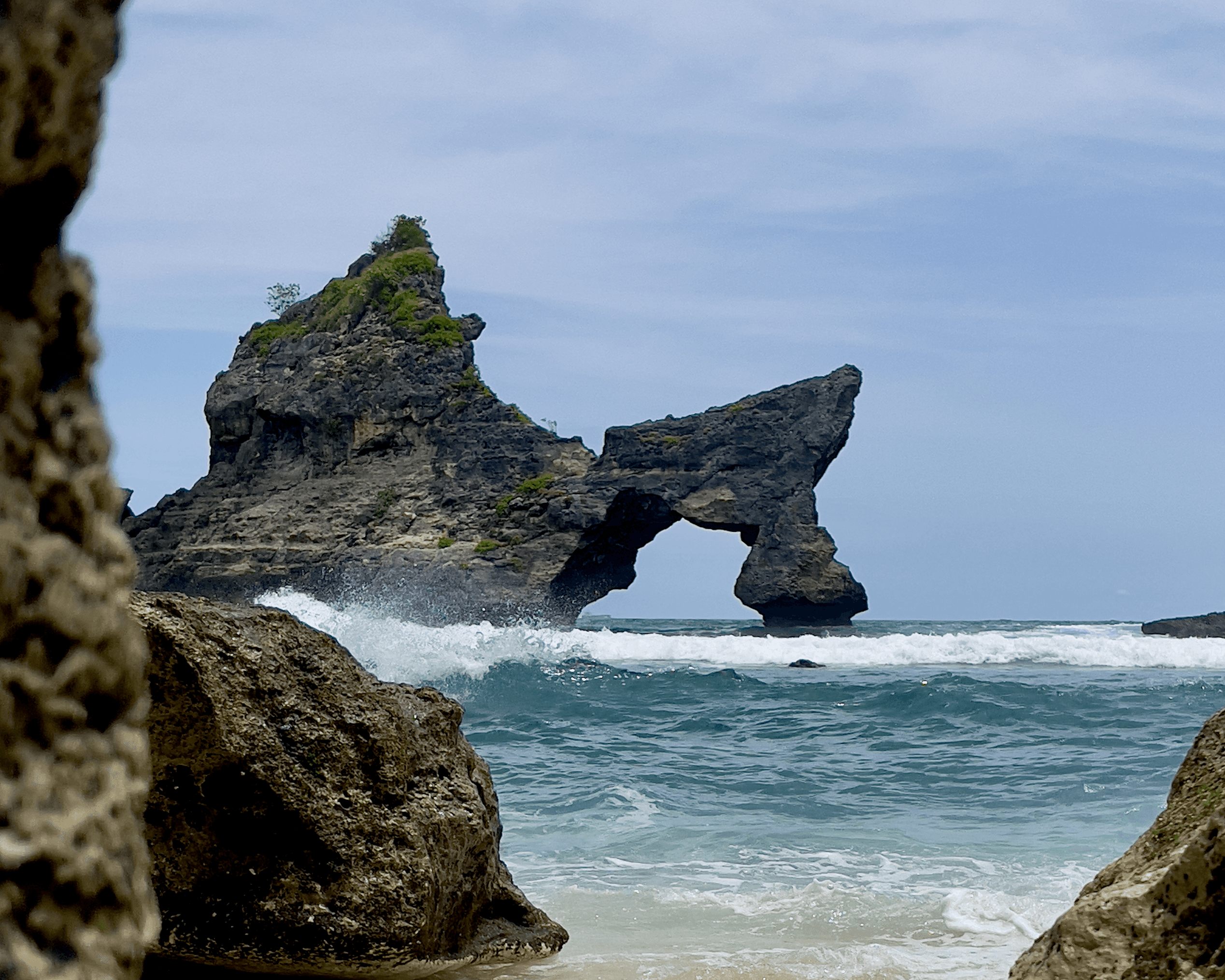 Arched sea stack with dragon head shape at Atuh Beach on Nusa Penida
