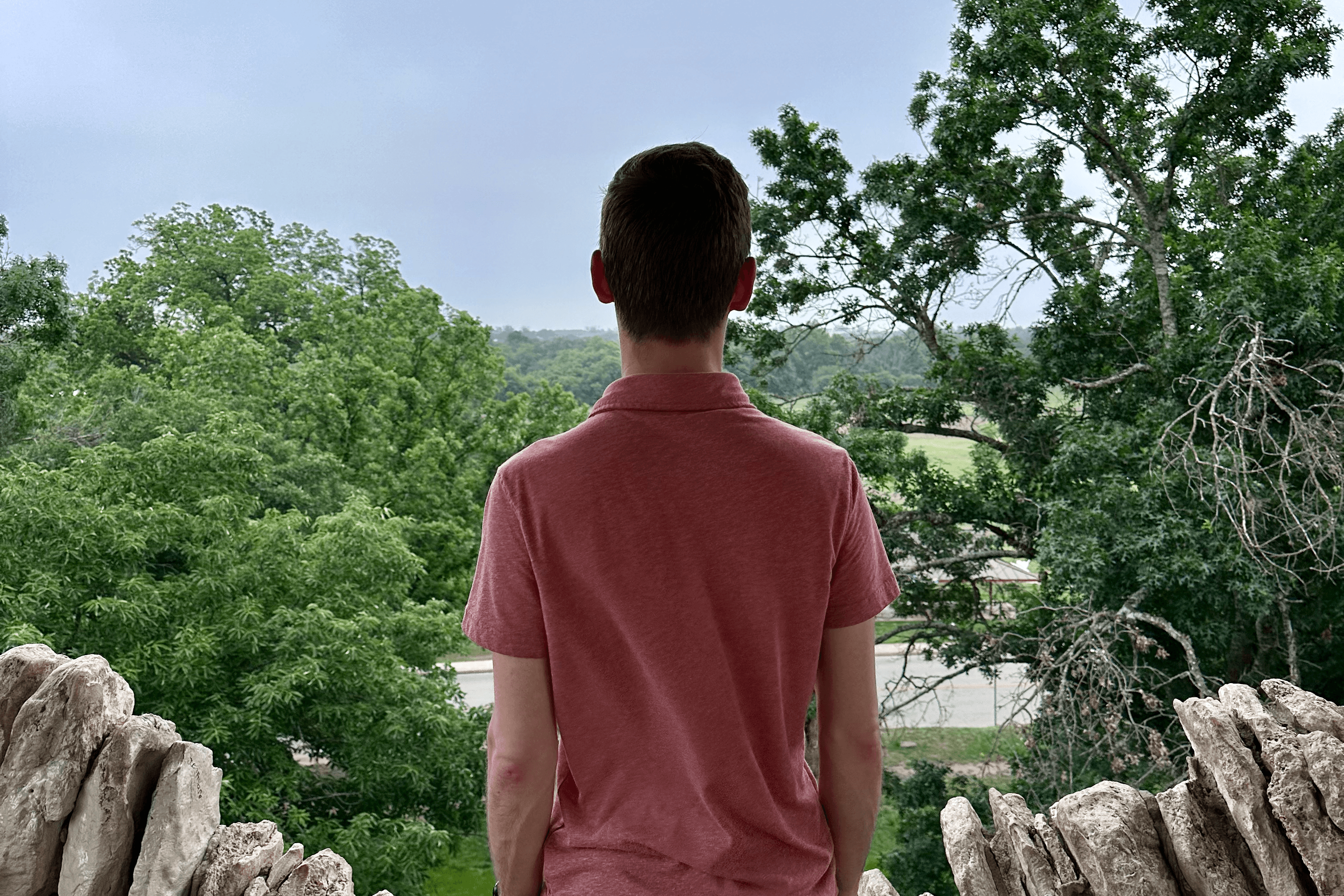 Matthew Fisher standing pensively in nature