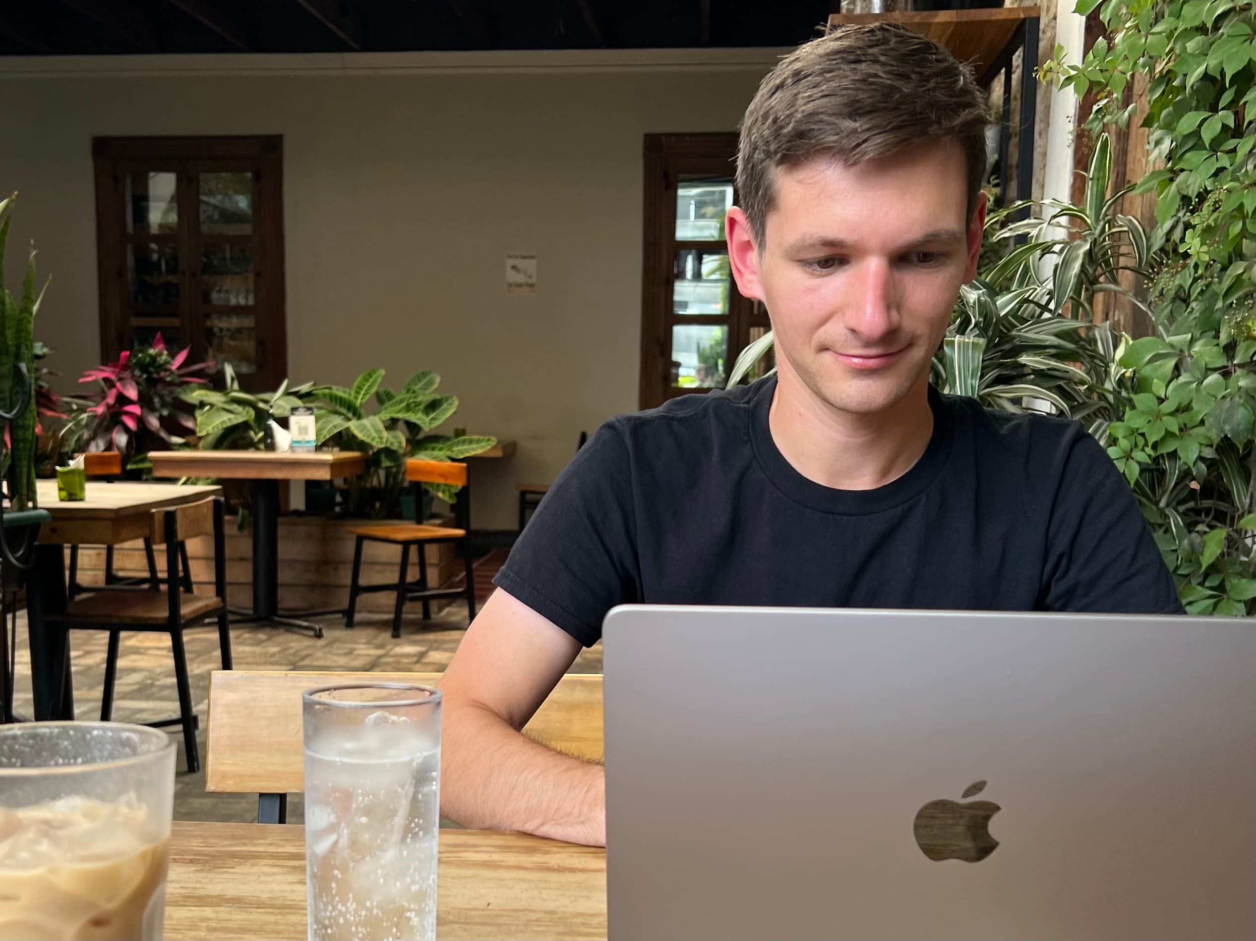 Matthew Fisher working on web design in a café